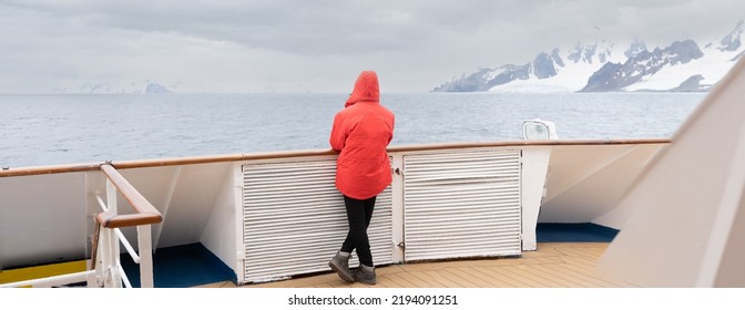 Passengers in red parkas on an Antarctic expedition at the bow of a ship	
 - Shutterstock ID 2194091251