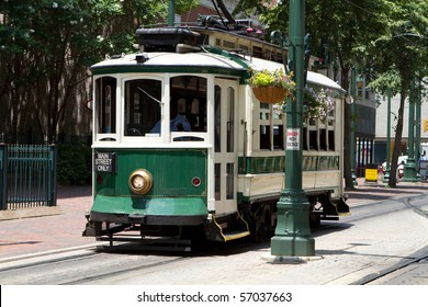 Passengers ride an electric trolley car down Main Street.