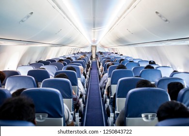 Passengers traveling by a plane, shot from the inside of an airplane