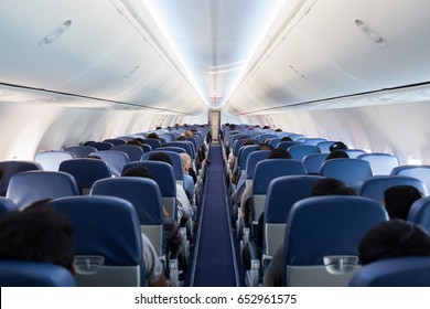 Passengers traveling by a plane, shot from the inside of an airplane