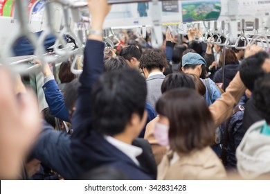 Passengers Traveling By Tokyo Metro. Business People Commuting To Work By Public Transport In Rush Hour. Shallow Depth Of Field Photo. Horizontal Composition.