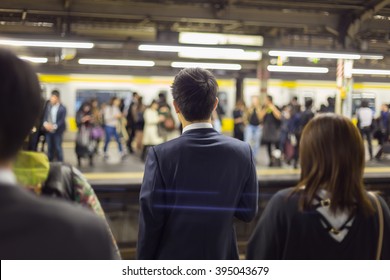 Passengers traveling by Tokyo metro. Business people commuting to work by public transport in rush hour. Shallow depth of field photo.  - Shutterstock ID 395043679