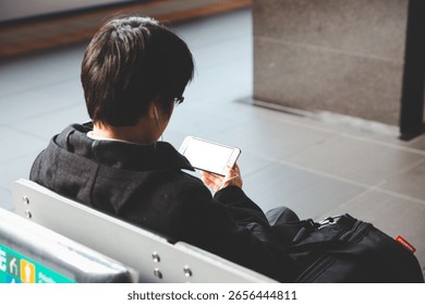Passengers are using mobile phones while waiting for the subway. - Powered by Shutterstock - Get 15% off with code: PIKWIZARD15