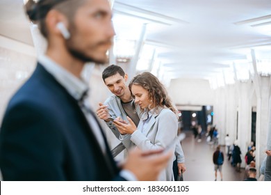 passengers using their smartphones while standing in the subway crossing. - Shutterstock ID 1836061105