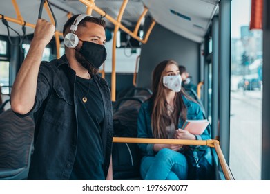Passengers wearing protective mask while riding a bus and keeping the distance due to a corona virus pandemic