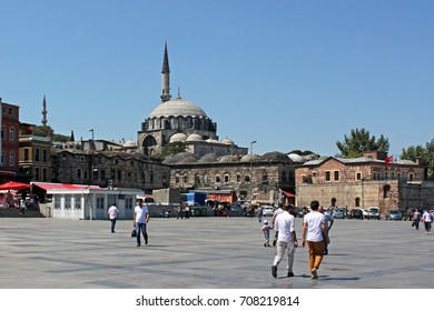 Passersby Walking On A Square In Front Of Rüstem Pasha Mosque In Eminönü, Istanbul