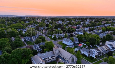 Passing over the courtyard located between a U-shaped church standing as an iconic structure and a beacon of hope within this city neighborhood.