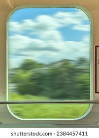 Passing scenery through the window of the train.