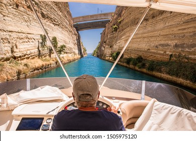 Passing through the Corinth Canal by yacht, Greece. The Corinth Canal connects the Gulf of Corinth with the Saronic Gulf in the Aegean Sea. Horizontal.