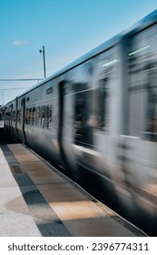 Passing train speeding by the platform at a train station 