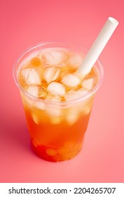 A Passion Fruit Boba Tea On A Bright Pink Background