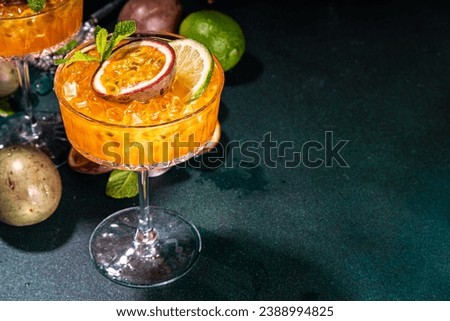 Passion fruit martini cocktail. Sweet pornstar alcoholic drink with fresh passion fruit and lime, with bar utensils copy space