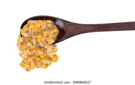 Passion Fruits Seeds In Wooden Spoon, Isolated On White Background. Passionfruit Or Maracuya Pulp, Exotic Fruit.