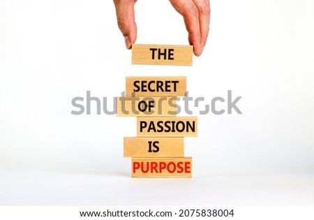 Passion and purpose symbol. Wooden blocks with concept words The secret of passion is purpose. Beautiful white background, copy space. Businessman hand. Business, passion and purpose concept.