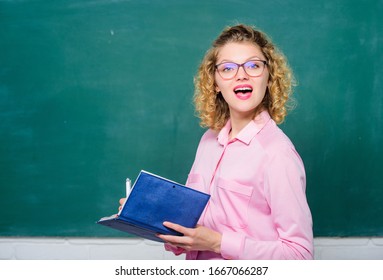 Passionate about knowledge. Pedagogue hold book and explaining information. Education concept. Teacher explain hard topic. Teacher best friend of learners. Woman school teacher in front of chalkboard.