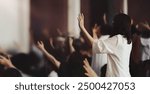 Passionate Christians with hands raised in prayer, Holy Spirit filled worship and church setting
