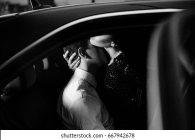 Passionate couple in the back seat of a car
