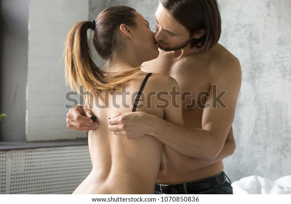 [Image: passionate-couple-kissing-man-unhooking-...850836.jpg]