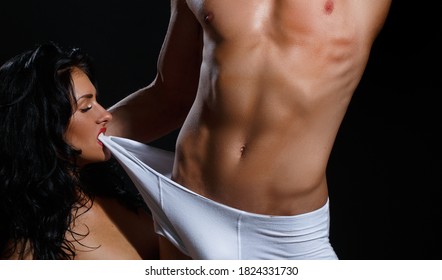 Passionate couple, sensual lovers. Human sexuality activities. Young woman undressed mans panties underwear or male boxer shorts briefs underpants