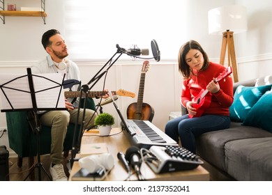 Passionate Duo Of Musicians Playing The Guitar And Singing A Beautiful Sad Song At Home