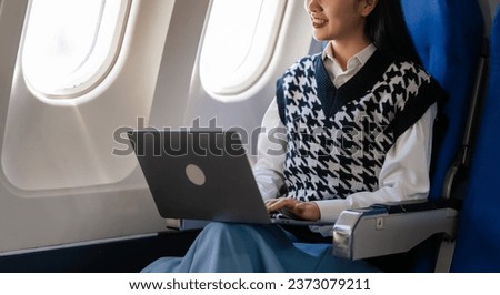 Passionate female asian chinese japanese people student aboard airplane, clutching textbooks, eagerly anticipating her overseas academic venture.