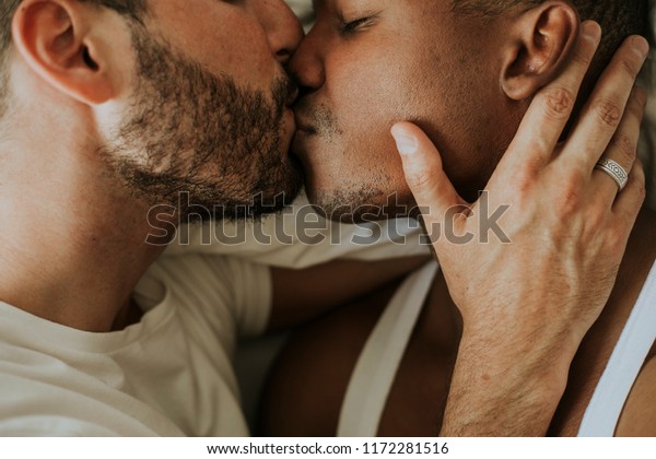 Passionate gay couple making\
out