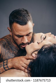 Passionate lover caressing arousing beautiful woman. Dominantning in the foreplay sexual game. Passionate woman with muscular latin lover. Dominant man. Night party - young lovers. Safety sex concept