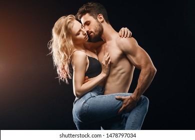 Passionate Man And Woman Having Sex In The Dark Room. Close Up Photo. Isolated Black Background