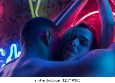 Passionate Nude Couple Kissing On The Background Of Neon Lamps.