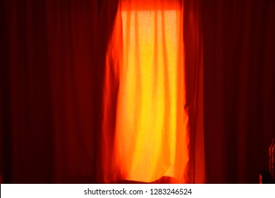 Passionate orange window curtain shading sunlight.