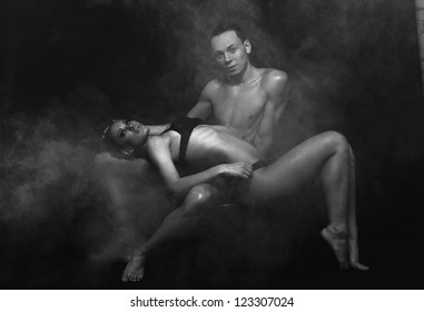 Passionate Sexual Couple Posing At The Studio With Fitness Body In Fume Isolated Passionate Sexual Couple Posing At The Studio With Fitness Body In Fume Isolated