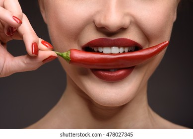 Passionate Woman Eating Hot Chili