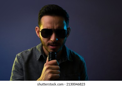 Passionate Young Man With Black Glasses Singing A Beautiful Sad Song With A Microphone 