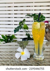 Passionfruit With Sparkling Water On Glass Table.