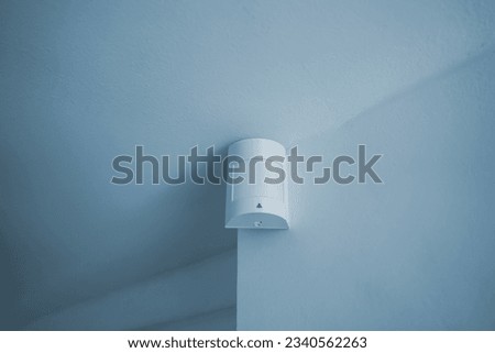 Passive infrared sensor at the wall.