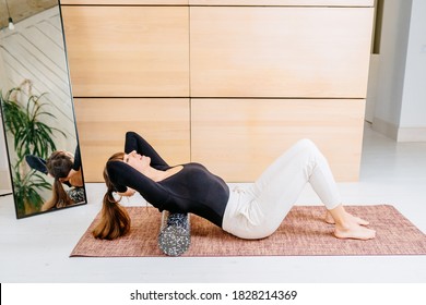 Passive Lifestyle, Consequence Incorrect Posture, Neck And Back Pain Concept. Female Sportswoman Uses A Foam Roller For Self-massage For Relaxation, Stretching Muscles And Back Pain.