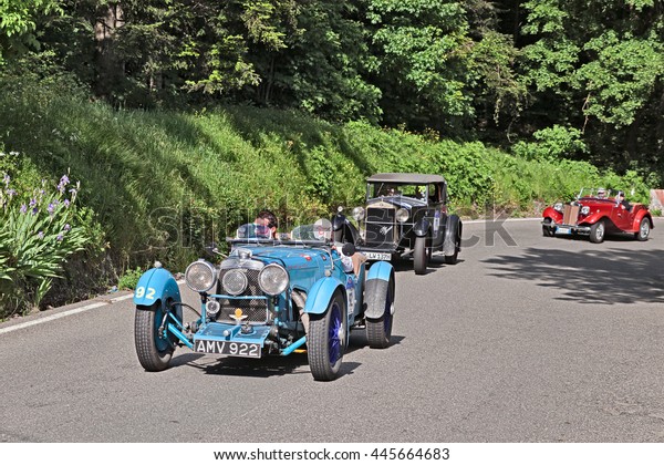 PASSO DELLA FUTA (FI), ITALY - MAY 21: driver and\
co-driver on an old racing car Aston Martin Le Mans (1933) in\
historical classic car race Mille Miglia, on May 21 2016 in Passo\
della Futa (FI) Italy\
