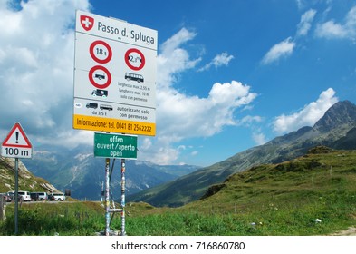 Passo Sluga ( Splügen Pass ) Marking The Boundary Between Italy And Switzerland. The Road Sign Indicating The Road Traffic Regulations.  