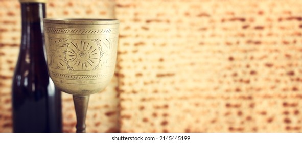 Passover background. Old Wine cup and matzoh (jewish holiday bread)