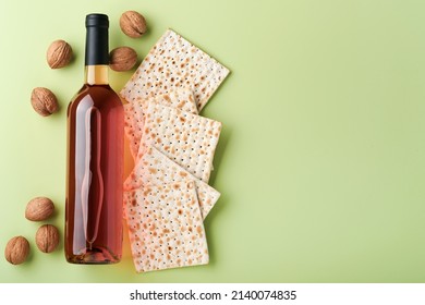 Passover Celebration Concept. Matzah, Red Kosher Wine And Walnut. Traditional Ritual Jewish Bread On Light Green Background. Passover Food. Pesach Jewish Holiday.