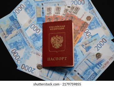 The Passport Of A Citizen Of Russia Lies On The Background Of Russian Rubles Of Various Denominations. Resilience Of The Economy And Financial System To Sanctions And Restrictions