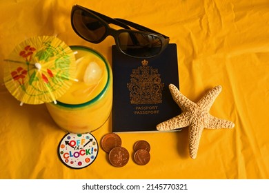 Passport, dark sunglasses, foreign currency tropical drink with tiny umbrella and 