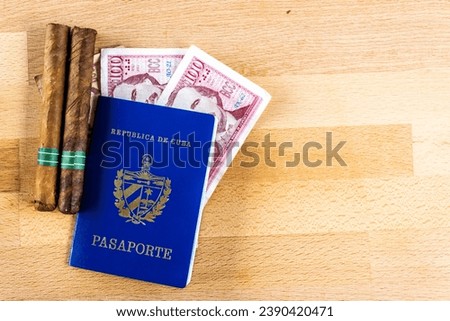 Passport document on a wooden board with Cuban cigars and money