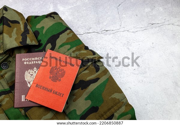 Passport, military ID on a military uniform\
and a citizen of the Russian Federation. Text in Russian PASSPORT\
OF THE RUSSIAN FEDERATION and MILITARY\
ID