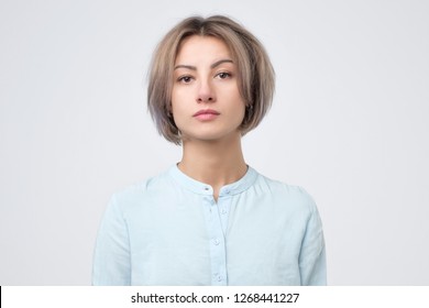 Passport photo. Portrait of european young woman in blue shirt