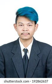 Passport Photo Of Young Attractive Asian Man With Blue Hair In Suit Isolated On White Background