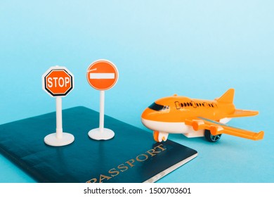 Passport stop signs and miniature airplane. Concept - a ban on entering or leaving the country. House arrest. - Shutterstock ID 1500703601