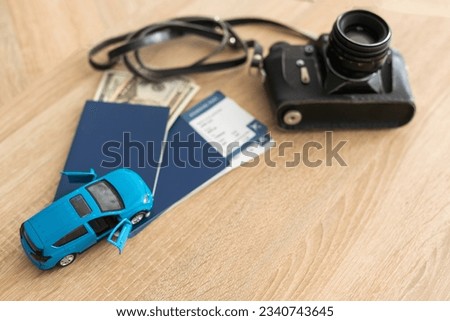 Passport, tickets and camera. toy car
