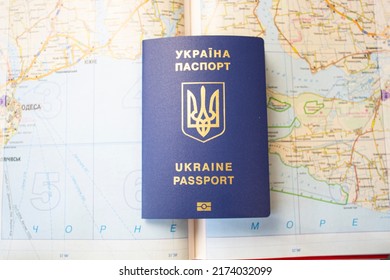 Passport Of Ukraine On The Background Of The Map, Seeking Asylum Abroad. Migration Crisis In Ukraine