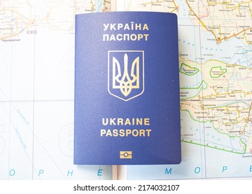 Passport Of Ukraine On The Background Of The Map, Seeking Asylum Abroad. Migration Crisis In Ukraine